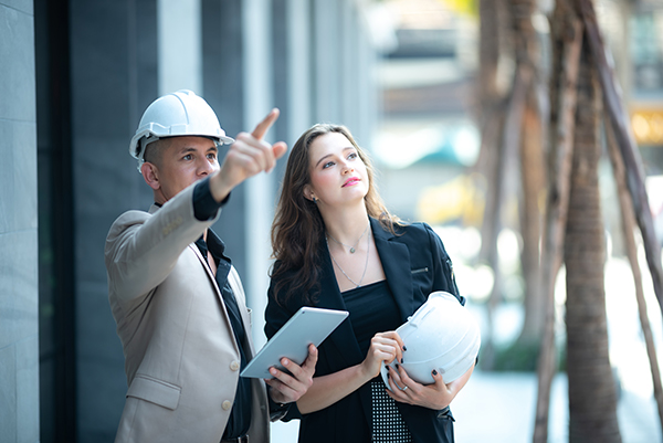 Young engineer wearing a helmet while inspecting work